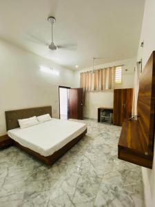 a bedroom with a bed and a table in it at Takery Resort in Chittaurgarh