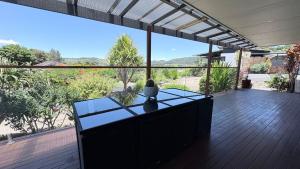 a balcony with a table and a view at Station on Pearce in Coffs Harbour
