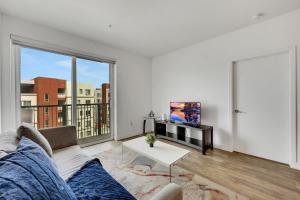a living room with a couch and a tv at Apart Hotel at Chinatown in Los Angeles
