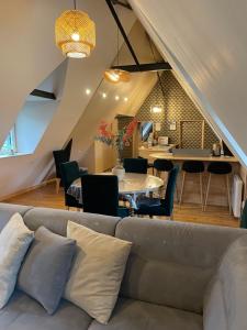 a living room with a couch and a table at Moulin entier rénové in Plounéventer