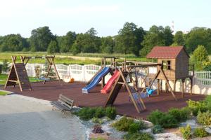 a playground with a slide and a swing set at Hotel Irys in Lublin