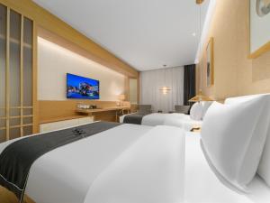 Ένα ή περισσότερα κρεβάτια σε δωμάτιο στο Jianguo Puyin Hangzhou Qianjiang New City Sijiqing Qingchun Plaza Store