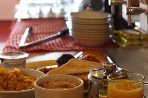 a tray of breakfast food with toast and orange juice at Stay Inn Manchester in Manchester