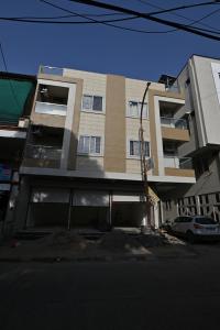 a tall building with a car parked in front of it at GharBar in Indore