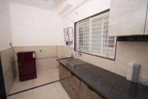 a bathroom with a sink and a window at GharBar in Indore