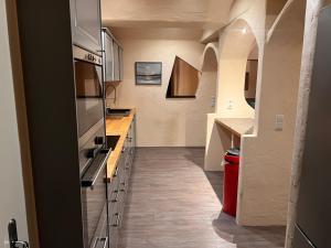 a kitchen with white counters and cabinets and a hallway at Villa Stern bei FFM Viel Platz und eigener Zugang in Nidderau +9 photos