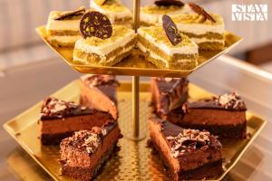 a bunch of different types of desserts on a plate at StayVista at Villa Lemonade with BBQ & Bonfire in Alibaug