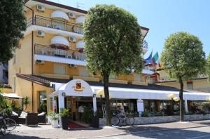 a building with a restaurant in front of it at Hotel Berna in Eraclea Mare