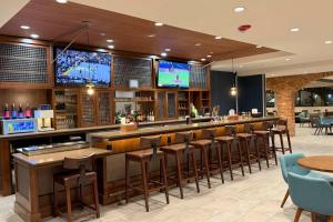 Clarion Hotel Rock Springs-Green River في روك سبرينغز: بار مع مجموعة من المقاعد وتلفزيون