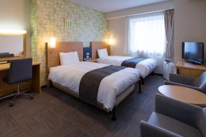 Ένα ή περισσότερα κρεβάτια σε δωμάτιο στο Comfort Hotel Hakodate