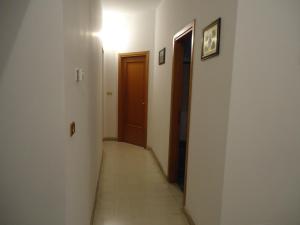 a hallway with two doors and a hallwayngth at Casa delle Aci in Acireale