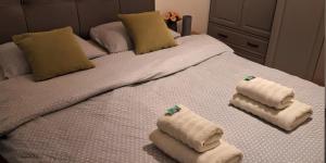 a bed with two folded towels on it at Apartman Angel in Osijek