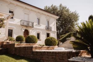 a large white house with a staircase in front of it at Palazzo Pecci in San Leucio del Sannio