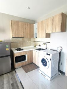 a kitchen with a washing machine and a washer at The new concept office plus in Ban Fon