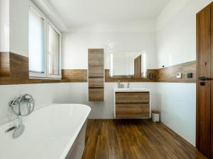 a bathroom with a white tub and a sink at Apartmány Bližší Lhota in Bližší Lhota +63 photos