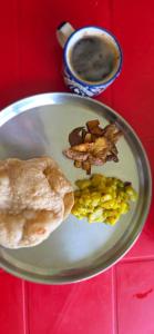 a plate of food with corn and a cup of coffee at Brookland Stays in Pedong