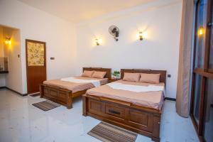 a bedroom with two beds in a room at The Cloud Nest Villa in Ahangama