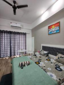 Una sala de estar con un sofá y un ventilador de techo. en Paramount Luxury Apartment, en Greater Noida 8 fotos más