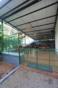 a pergola with a chicken cage in a house at Coffee Courtyard in Kurchi +8 photos