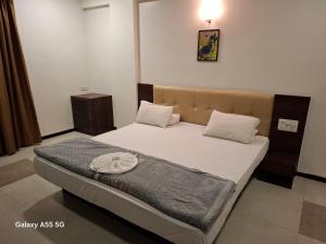 a bedroom with a large bed with at Hotel Pride Executive in Satara