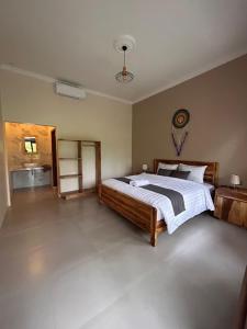 a bedroom with a large bed in a room at Greenfield-Lombok in Tetebatu