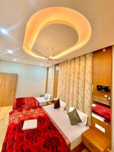 a bedroom with a large bed with a red blanket at The Kridha Palace in Jāmb +14 photos