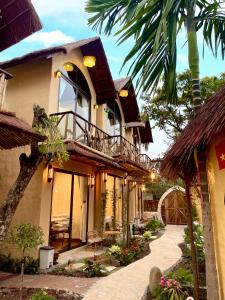 a house with a balcony and a courtyard at Tam Coc Sora - Traditional Home - Center in Vũ Lâm +72 photos