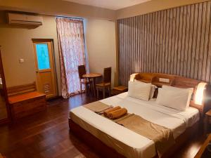 a bedroom with a large bed in a room at Omega Regency Colombo in Colombo