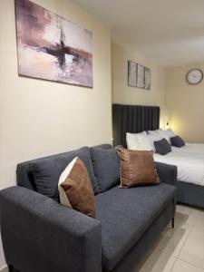 a living room with a couch and a bed at The Millennial by Safar Apartments in Umhlanga +31 photos