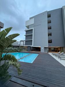 a building with a swimming pool in front of a building at The Millennial by Safar Apartments in Umhlanga