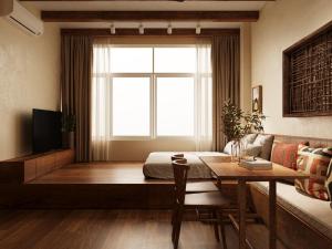 a living room with a table and a window at PhaTea Neoclassical Style Building - near Old Quarter in Hanoi