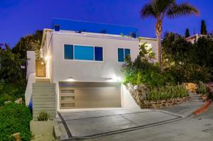 een wit huis met een garage 's nachts bij “Backyard Is OMG” Spa Pool BBQ Game Room Views in San Diego