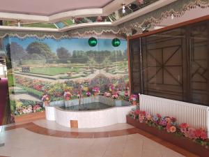 a room with a mural of a garden with flowers at Hotel Qasr-e-Naz in Dargai