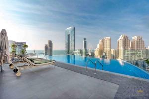a swimming pool with a view of a city at Casa Royale Vacation Home - Dubai Marina in Dubai