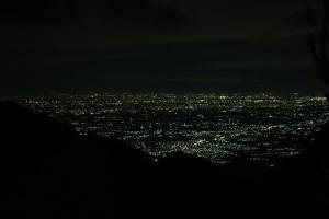 a view of a city lit up at night at Moksha at Infinity Valley in Kotagiri
