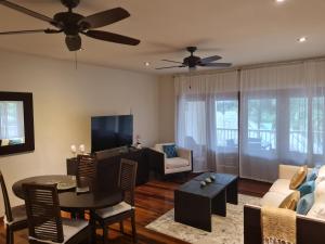 a living room with a couch and a table at Lovely 1-Bedroom Apartment - Pool, Private Beach in Gaynors