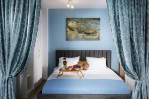 a bedroom with a bed with blue curtains and a table at Free Parking On Premises Huge Terrace in Sofia