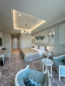 a hotel room with a bed and a couch at Oq uy Hostel Chilonzor in Tashkent