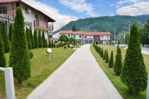 a walkway in front of a building with trees at Motel Predejane in Predejane +69 photos