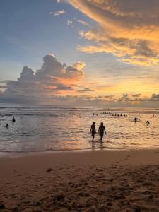two people walking on the beach at sunset at Devo's place in Galle
