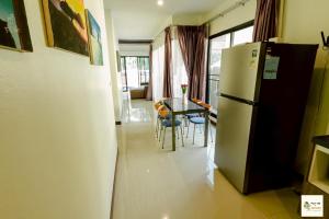 a kitchen with a refrigerator and a table with chairs at Aonang Soi 1 Villa 2bedroom2bathroom in Ao Nang Beach