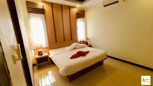 a bedroom with a bed with a red bow on it at Aonang Soi 1 Villa 2bedroom2bathroom in Ao Nang Beach +29 photos