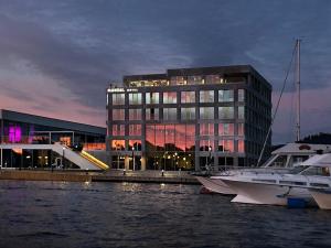 a large building with a boat in the water at Mandal Hotel in Mandal