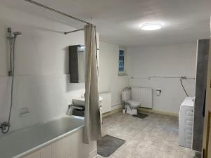 ein Badezimmer mit Badewanne und Toilette in der Unterkunft Boxenstop Ossendorf in Warburg + 9 Fotos