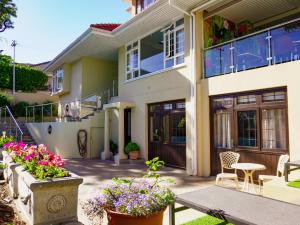 a house with flowers in front of it at Sundown Manor Guest House in Cape Town