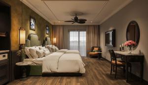 a bedroom with a large bed and a desk at Dream Future Vang Vieng Hotel in Vang Vieng