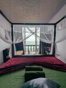 a bedroom with a canopy bed with a view of the ocean at Villa Sea View in Galle