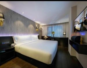 Postel nebo postele na pokoji v ubytování Orange Hotel Hangzhou West Lake Hefang Street