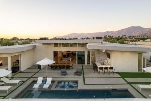 a house with a swimming pool and a patio at Neon @ Elemento49 Pool Spa Sleeps 16 in Desert Groves Mobile Home Park