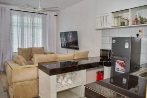 a living room with a couch and a refrigerator at Swara house in Ukunda